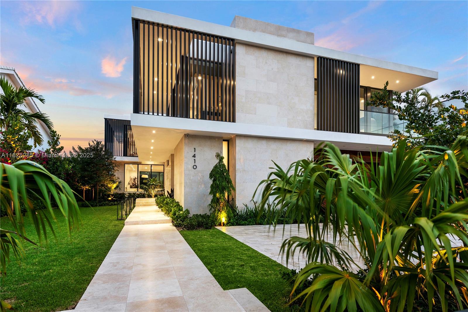 Villa Nova is a stunning modern design located within gated Biscayne Point. Newly constructed to capture breathtaking sunrise and sunset views, perfect for entertaining. Premium finishes, the home features 6 bedrooms and 7 bathrooms across an 11,250SF lot with 75ft of prime waterfront. Architectural elegance is expressed through limestone cladding, aluminum louvers, and white oak flooring. The exterior is finished in travertine, while the garage is wrapped in rich ipe wood. A Boffi XILA walnut kitchen and limestone-clad Boffi bathrooms enhance the luxury. Venetian plaster walls, soaring ceilings, and a floating concrete staircase create an atmosphere of refined architectural sophistication. Enjoy a heated saltwater pool and spa, along with fully integrated smart home technology.