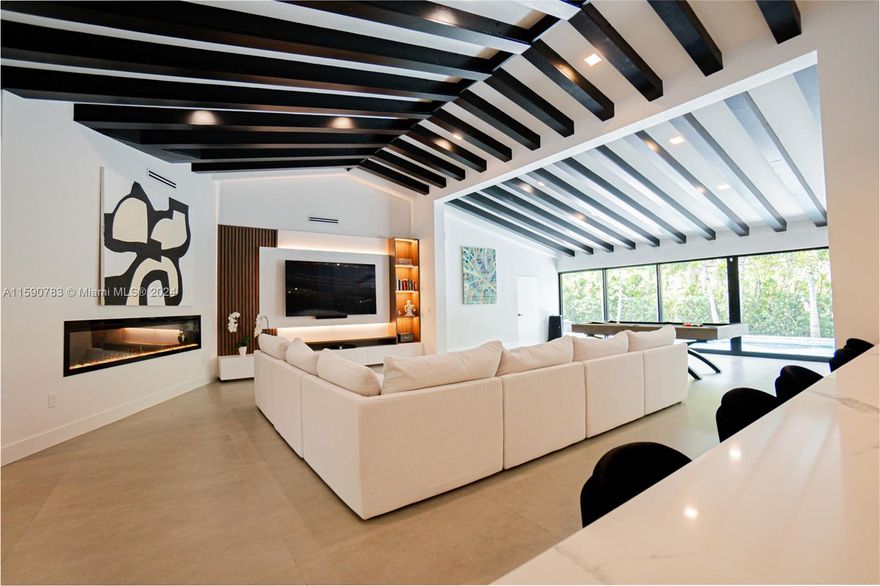 Newly renovated in 2023, this stunning 4-bedroom, 3.5-bath home in Coral Gables spans 3,332 SF+/- on a 0.26-acre+/- lot. Located in the coveted Sunrise Point area, this property features a contemporary design with clay porcelain tile floors, Bianco Carrara marble bathrooms, and a chef’s kitchen with Thermador appliances. The primary suite includes walk-in closets, a steam shower, and access to the outdoor patio and pool. Enjoy seamless indoor/outdoor living with a new 11’ deep Diamond Bright saline pool, Sonos speakers, and an 8-10 car circular driveway. Equipped with smart home technology and just 0.3 miles+/- from Biscayne Bay and 5 miles+/- to Brickell, this home offers the best of Miami living.
