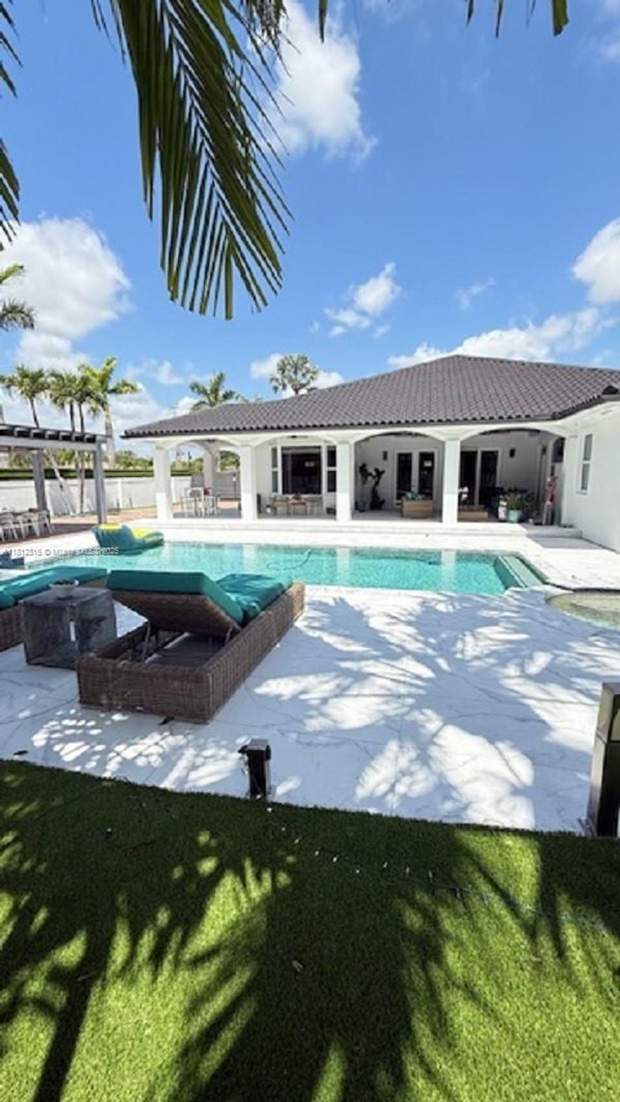 This stunning, fully gated one-story estate is ideally located in the heart of Miami, just minutes from top-rated schools, popular local hotspots, and a sprawling public park. Boasting nearly 4,183 square feet of elegant living space (over 4,732 total square feet), this meticulously designed residence offers 4 spacious bedrooms and 3 luxurious full bathrooms. Step inside to discover an expansive open-concept layout featuring a designer kitchen with premium finishes and top of the line appliances seamlessly flowing into the living area. A butler’s pantry leads to a spacious 3-car garage, EV-ready to accommodate up to six vehicles.The backyard is a private oasis, featuring a spectacular pool with a spa and a beautifully designed entertainment area.