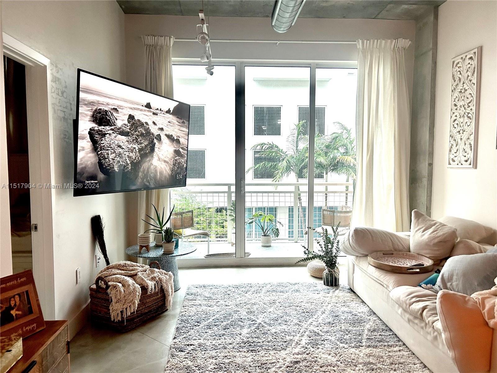 UNFURNISHED OR FURNISHED. Furniture CAN be removed if desire! Polished concrete floors, high ceilings, exposed industrial piping and cement columns. Large impact sliding doors in living room and large impact windows in bedroom. Apartment has lots of lighting with North facing windows, avoiding direct sun. Comes with curtains including blackout in bedroom. Walk-in closet with built-in shelving. Laundry closet with washer & dryer and built-in shelving. Hall closet with built-in shelving. Large bathroom with 72" stone top vanity. Drawers equipped with trays for organization. Bedroom with queen size memory foam bed, 7 drawer vanity and night table. Kitchen includes kitchenware, coffee maker, Ninja blender, countertop toaster-oven, etc. Balcony has both city and partial bay view with seating.