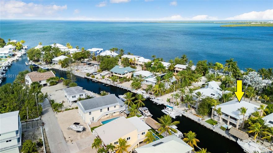 Your Waterfront Island Retreat Awaits – Freshly Updated & Move-In Ready Experience relaxed Florida Keys waterfront living in this bright, spacious canal-front home featuring a brand-new metal roof for timeless coastal style, durability, and peace of mind. Located in a friendly Upper Keys neighborhood on one of the area’s deeper canals, this property offers protected boating, tranquil water views, and an ideal setting across from bayfront homes. A welcoming foyer with interior staircase opens to an airy living space designed for effortless island living. The crisp white kitchen showcases quartz countertops, ample cabinetry, and generous prep space—perfect for everyday meals or entertaining. Living and dining areas flow seamlessly to a waterfront balcony, ideal for morning coffee, outdoor dining, or sunset relaxation. The turnkey residence includes three comfortable bedrooms with elegant Crema Marfil marble flooring and updated bathrooms. Practical features include ample parking, covered carport, abundant storage, attic space, and two permitted additional rooms totaling 576 sq ft, offering flexible use. Outdoors, enjoy a canal-side patio, tiki area, and hot tub—perfect for unwinding under the stars. Boaters will love the 52-ft concrete dock with davits and quick bay-to-ocean access for fishing, diving, and sunset cruises. Convenient to waterfront dining, marinas, shopping, and everyday amenities, and just 50 minutes from Miami International Airport.
