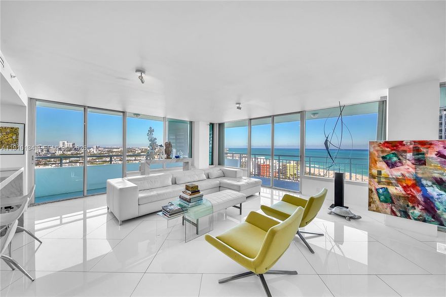 Location and Lifestyle are delivered in this breathtaking 23rd-floor corner residence in South Pointe Tower. Unparalleled direct ocean + city views through floor-to-ceiling glass windows. Every room opens to private 90 ft wraparound terrace. This designer open loft (re-imagined from a 2 bed + den) delivers a luxurious modern aesthetic with white glass flooring throughout and Carrara marble finishes. The open-concept chef’s kitchen features sleek stainless steel appliances + an impressive 15-foot Carrara marble island — perfect for entertaining. The residence boasts 2.5 spa-inspired Carrara marble bathrooms and includes two indoor parking spaces.  Building just completed a $30 million master renovation (paid in full). Private 2 car garage available seperately - perfect for your  exotic cars.    This captivating open loft-design is easily converted back to a traditonal 2 bedroom + den layout and we have available contractors upon request.