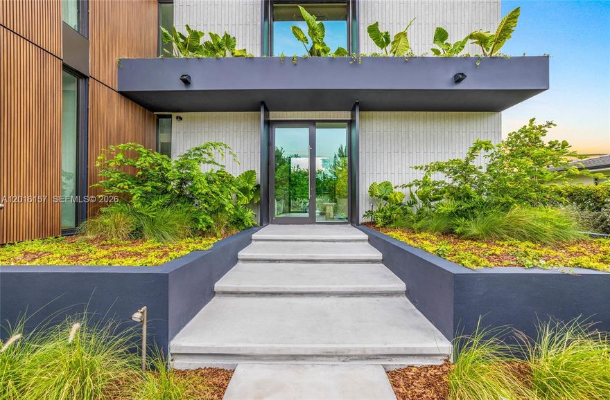Stunning modern residence in the heart of Miami Beach offering approximately 4,000 SF of interior living space and 4,700 SF total area. This exceptional 5-bedroom, 5.5-bathroom home showcases top-tier finishes and meticulous custom craftsmanship throughout. The property features fully custom millwork including a designer kitchen equipped with top-of-the-line appliances such as Miele and a premium Forno Galiano cooktop, elegant wall paneling, built-in closets, and custom floor-to-ceiling frameless interior doors. Premium materials elevate every space, with sleek limestone flooring on the first level and beautiful Italian engineered wood floors upstairs. The home’s lighting was thoughtfully designed by a professional lighting designer, enhancing architectural details and creating a warm, sophisticated ambiance throughout. Designed for both comfort and sophistication, the home includes smart home technology and a bright, open layout ideal for modern living and entertaining. Step outside to a spectacular pool area featuring a waterfall for a relaxing ambient sound and a jacuzzi, creating a true private resort-style experience. Expansive front yard space enhances the home’s presence, while the fully fenced property offers privacy and security.