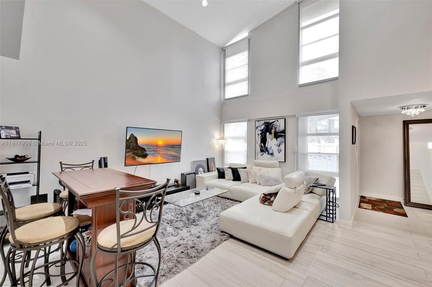 Discover the charm of this remodeled two-story townhouse in a gated community in Aventura. Step into a warm & inviting layout, flooded with natural light thanks to a double-height ceiling & large windows, a modern kitchen boasting sleek cabinetry, quartz countertops & SS appliances, a bedroom downstairs also ideal as a home office, tile floors & led lighting throughout, new A/C & full size washer/dryer. Upstairs leads to a spacious primary suite with a en suite bath & a huge custom-made walking closet. The outdoor enclosed patio is perfect for entertaining & BBQing. Nested in a private courtyard of only 22 townhouses located in a hi-rise complex, provides 2 exceptionally deed-covered parking spaces & access to all amenities: 2 pools, tennis courts, shuffleboard, gym & rentable boat slips