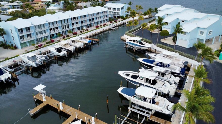 Exclusive and seldom available offering in the gated community of Key Largo Yacht Club. Completely remolded turn key 3Bedroom 3 Bath 2 Car garage ocean view town home with a Deeded Boat Slip that includes a 15,000 LB lift your steps from your door. This is a beautiful turn key unit completely furnished and decorated with no expense spared. The 1st level encompasses your own patio for entertaining and grilling. The 2nd level is all about the kitchen / dinning and living / family room experience. The 3rd level is completely dedicated to a magnificent primary suite with a large bathroom and walk-in closets. Located in a beautiful 10acre secured community of only 24 units this community includes a modern pool, club house, tennis / basketball courts and trailer parking
