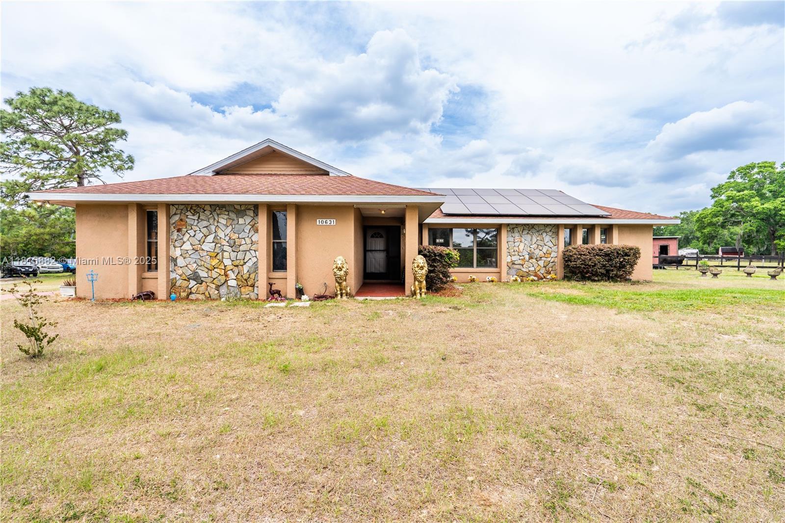 Welcome to your private haven, within a FOUR-MINUTE drive from The World Equestrian Center. This stunning 6.6+ acre flag lot masterfully combines privacy and convenience, enveloped by mature trees and fully fenced for your peace of mind. Step inside this beautifully appointed three-bedroom, two-bathroom home, built in 1991, featuring an inviting open floor plan that flows seamlessly. Host formal dinners in the airy and open dining room, unwind in the air-conditioned back porch (formerly a fourth bedroom), and enjoy the oversized workshop and RV garage with hookups, feed area and air controlled attached shed great for all animal needs, your vehicles, and projects. Updated Well 2020, Roof 2016, FEMA X, 3 stall pole barn and FULLY FENCED.