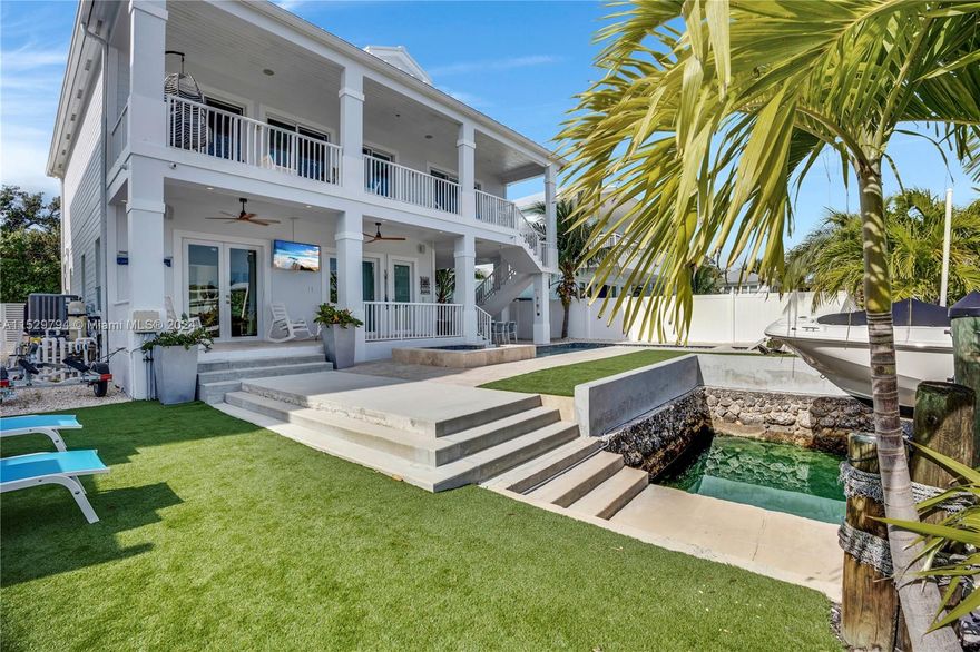 Fully Furnished 4 BR/3.5 Bth Key Largo 2 story home with pool & Jacuzzi Outdoor Kitchen on the water, ocean side with a concrete cut in slip & canal slip, direct ocean access Elegant foyer followed by a private 1 bedroom suite downstairs, including a full bathroom, living room and large wet bar, and washer & dryer. Glass stair case will lead you to the second floor living & dinning room and the main kitchen with a wine cooler The other 3BR/3 bth are on this level including the master bedroom with remote curtains and blinds & another washer and dryer. You will also find a lanai overlooking the pool, canal and ocean views. The home is equipped with 2 separate central AC units & surround sound systems. Owners park with boat ramp, tiki & picnic tables.