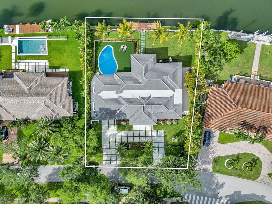 Basque in the warmth of golden hour while overlooking the pristine Gables waterway. Situated on a 14K+ sq ft lot, this contemporary home offers a split plan with 4 BR/4 BA + 2 car garage. A wall of windows & French doors allow for an abundance of natural light & 125 ft of historic waterway vistas. Recently renovated, featuring European kitchen cabinets w/gorgeous marble counters, large primary w/en suite & custom closets, open concept living & new dock. Purposeful outdoor lighting enhances lush landscaping & creates a fabulous tropical oasis. Enjoy the best of Miami as you entertain family & friends under a covered terrace or poolside, cooking is made easy with an outdoor grill/egg smoker + patio allows for large gatherings. Centrally located, everything is just a car or boat ride away!