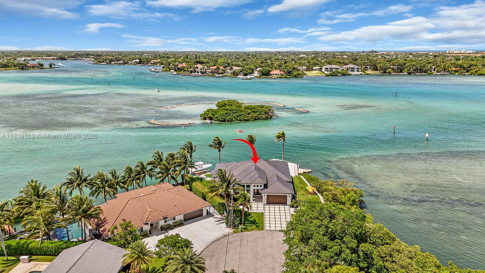 Jupiter’s iconic “Home on the Point”—walkout access to a sandbar—offers a rare waterfront lifestyle. Newly built in 2021, this 3BR/3BA+office/den showcases sweeping water views throughout the entire home. Enjoy ocean wildlife from your backyard during the day while birds nest and feed on the island nightly. This home offers a private dock & boat lift, stunning porcelain-tile pool, floating dock, kayak launch all designed for outdoor living. Designer features include a grand primary suite with expansive walk-in closet and spa-style bath, gourmet kitchen w/ pantry, a dedicated office, electronic window shades, laundry room, 2-car garage, extra boat/RV space, community boat ramp. This is Jupiter’s most coveted address and a one-of-a-kind opportunity to own a sanctuary on the water