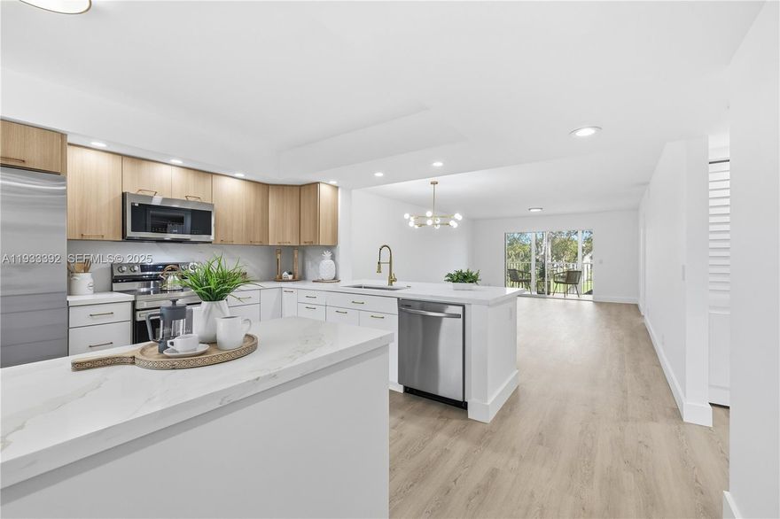 Welcome to this totally updated 2/2 unit with a lake view that greets you as you enter the front door, oasts a contemporary kitchen with sleek, ceiling-high cabinets, quartz countertops, and brand-new appliances. Enjoy the beauty of brand-new vinyl flooring, freshly painted interiors, and elegant, bathrooms. Breathtaking views. Enjoy the convenience of an in-unit washer and dryer. The HOA is $520/month plus CVP $280/month, and includes water, cable, internet, and access to endless amenities, including a million-dollar clubhouse. Located in Cambridge I at Century Village, one of Pembroke Pines most desirable 55+active adult communities, minutes from The Shops at Pembroke Gardens and major highways.