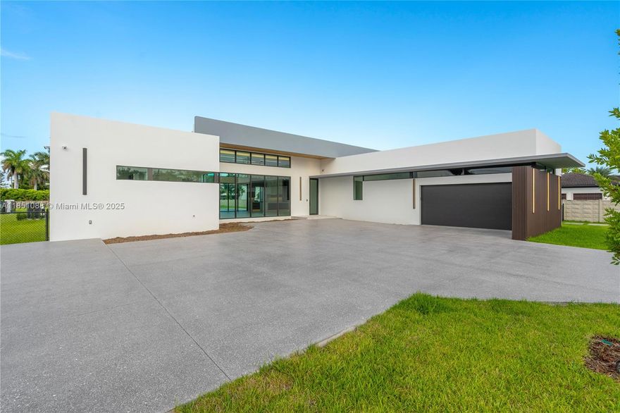 Immerse yourself in this 2025 architectural masterpiece, offering over 6,000 sq ft of pure elegance. This exclusive estate features 5 bedrooms, 6.5 meticulously designed bathrooms, and a executive office.  Every inch of this home exudes sophistication, from the soaring ceilings to the expansive floor-to-ceiling glass that floods the interiors with natural light and showcases the home’s impeccable design and seamless indoor-outdoor flow. A grand 20-foot foyer introduces an open-concept layout adorned with custom finishes, state-of-the-art smart home technology, and a surveillance system for total peace of mind. The backyard is a private sanctuary, with an oversized pool, spa, and a custom outdoor kitchen perfect for entertaining. Ideally located near Miami Airport and top-rated schools.