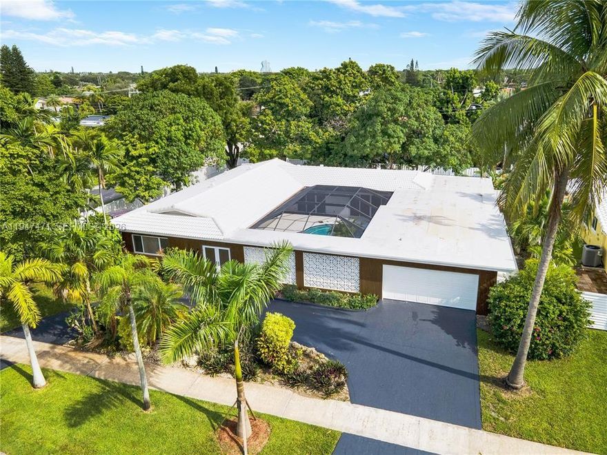 A rare opportunity in prime Hollywood Hills. This fully magneficent residence offers refined modern living with Italian flooring, a custom European kitchen, and beautifully designed bathrooms throughout. The open concept layout flows effortlessly to the pool, enhanced by striking custom architectural lighting and serene outdoor views. Situated on an oversized 15,000 SF corner lot with mature mango, avocado, and coconut trees, a grand circular driveway, and a private in-law suite with its own entrance, ideal for guests or extended family. Centrally located near major highways, top shopping, hospitals, Hard Rock Casino, downtown Hollywood, just 12 minutes to Hollywood Beach, 15 minutes to Fort Lauderdale Airport, and 30 minutes to Downtown Miami & the Design District.