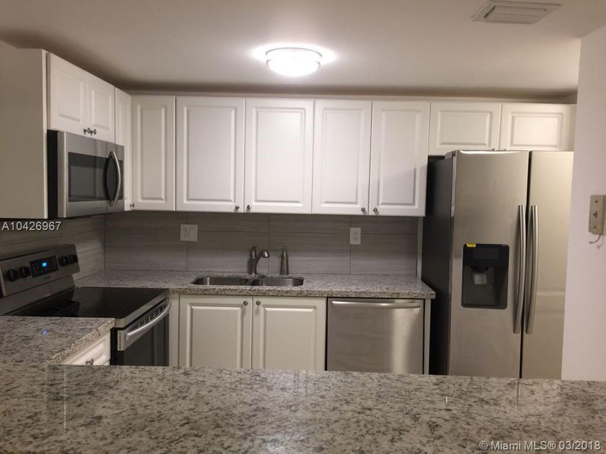 2 Parking assigned. Centrally located upgraded 2/2 unit, remodeled kitchen with granite counter to, updated bathroom, tile floors, stainless steal appliances, new washer and dryer, accordion shutter.  Community offers pool, path for walk around, tennis, elevator,  enough Parking location for visitors.  Excellent location, just behind Walmart and new shopping centers.  Target and Home Depot are a 5 minute drive each. Unit is minutes away from the highway.