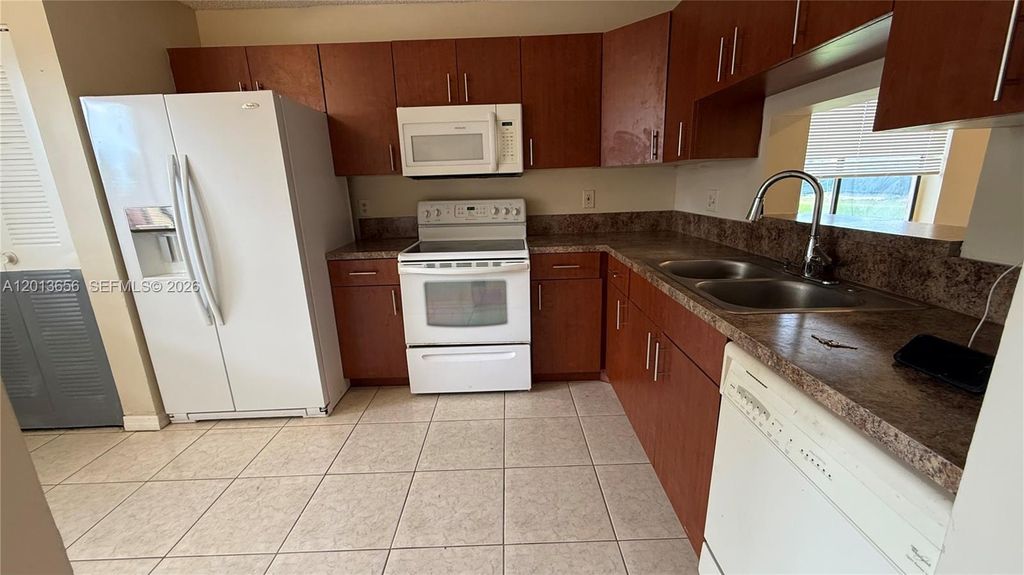 Photo of 8011 Southgate Blvd #L1, North Lauderdale, FL 33068 (MLS # A12013656)