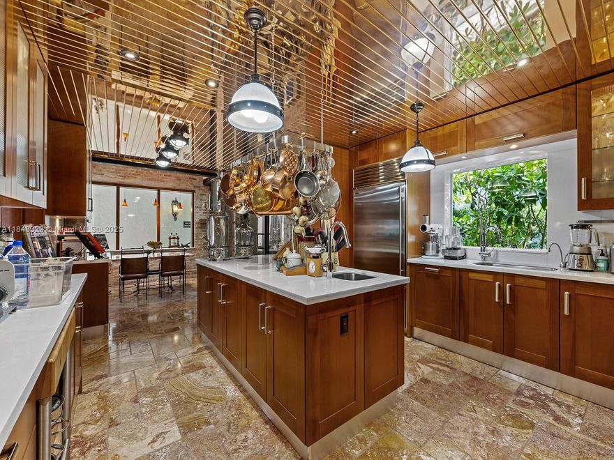 Located in the exclusive gated community of Chateaux Estates, this single-family home blends bold New York modern industrial design with the comfort of luxury living. It features 4 bedrooms and a service quarters, with a layout perfect for everyday living and entertaining. A custom MiaCucina kitchen anchors the home with sleek, modern style. Wine lovers will enjoy two climate-controlled cellars—one for 1,700 bottles, the other for 1,000—plus a cozy wine and bar room. A high-efficiency air purification system in the A/C helps reduce allergens and germs. Enjoy access to a pool, playground, tennis courts, dog areas, and clubhouse. A rare chance to own a truly unique home in one of North Miami Beach’s most desirable neighborhoods.