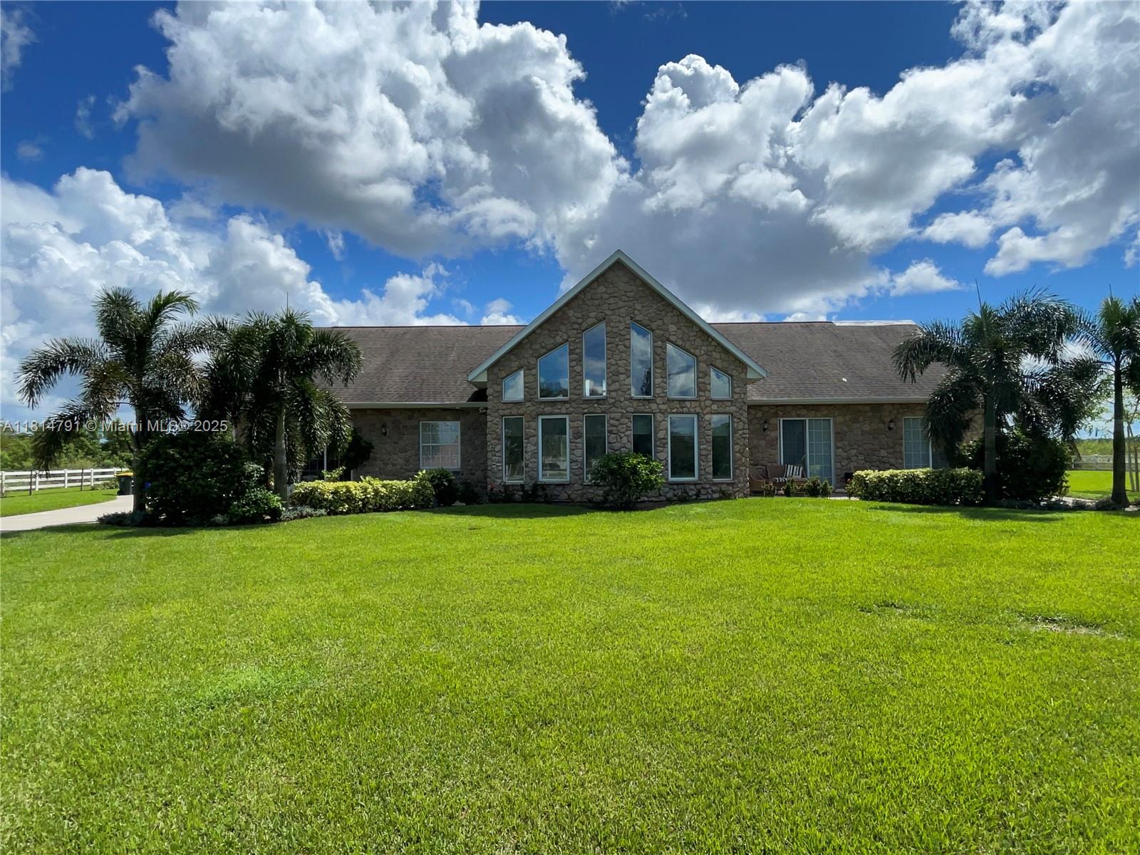 Discover your dream homestead on 5 fully fenced, ag-zoned acres! This unique property offers a spacious 4-bed, 2.5-bath home with a 2-car garage and everything you need for modern country living. The massive 66x30 steel barn (2022) features a brand-new 5-ton A/C (2024). Bring your animals—there’s a chicken coop, animal barn, and stalls already in place! Enjoy fresh fruit from your own starfruit, plantain, grape, and fig trees. Relax in the large above-ground pool or entertain on the newly screened-in back patio (2024). Plus, a 4-inch well and upgraded water filtration system (2024) ensure you're set up for self-sufficient living. Roof 2017,Two welcoming front porches complete the charm. Rare find—don't miss it!