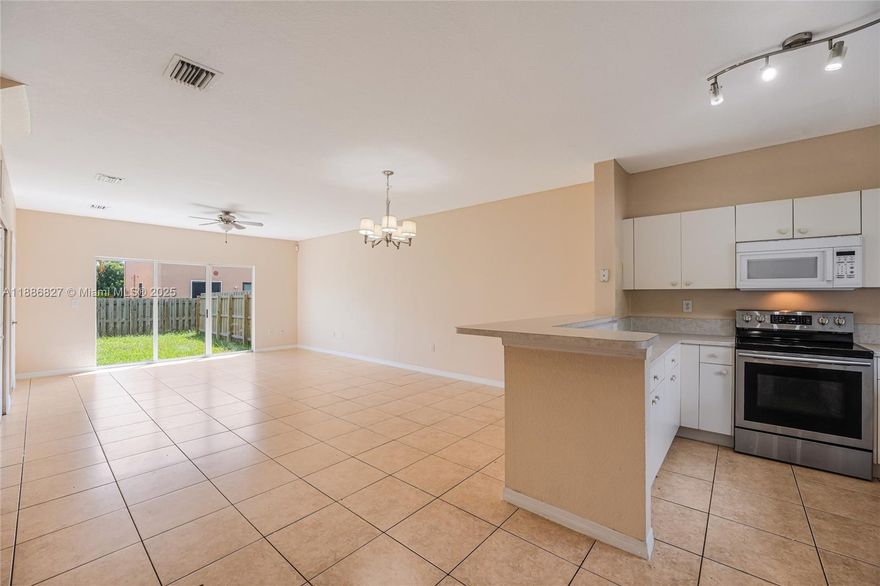 Beautiful two-story townhouse with 3 bedrooms, 2.5 bathrooms, with tiled floors in the living areas and wood flooring in bedrooms. The bright living room overlooks a private fenced backyard, perfect for relaxation. Modern kitchen includes stainless steel appliances, granite countertops, and ample storage. A full-size washer & dryer are included. The primary suite has an en-suite bathroom, while the additional bedrooms share a well-appointed bath. Enjoy private parking, a secure community, and small pet-friendly policies. Conveniently located near major highways, shopping, and dining.