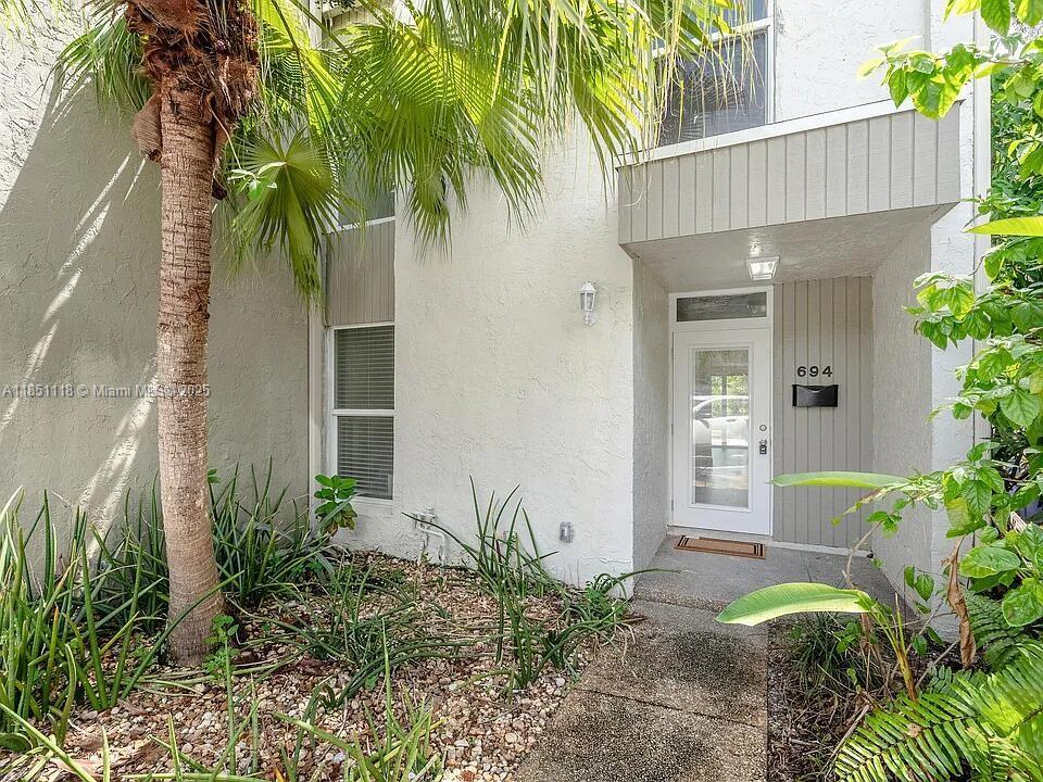 Location! Water View! Updated! .3 miles from the heart of Wilton Manors, this stylish dual-primary townhome is on a quiet, low-traffic street. New roof, AC, hurricane-impact windows, and soft-close dovetail cabinets. Enjoy water views from the private balcony. Bring your paddleboard or fishing pole, and HOA allows docks with approved permits and plans! Unique step-up area for art, piano, plants, or Murphy bed. This property includes a mid-century desk with vintage screen, LVP floors, tiled bathrooms, fresh paint and drywall updates, termite treatment with transferable warranty, and an outdoor storage building—large, spacious yard. 2 assigned parking spots. Seller is a licensed real estate agent in NC. Buyers' agents welcome.
