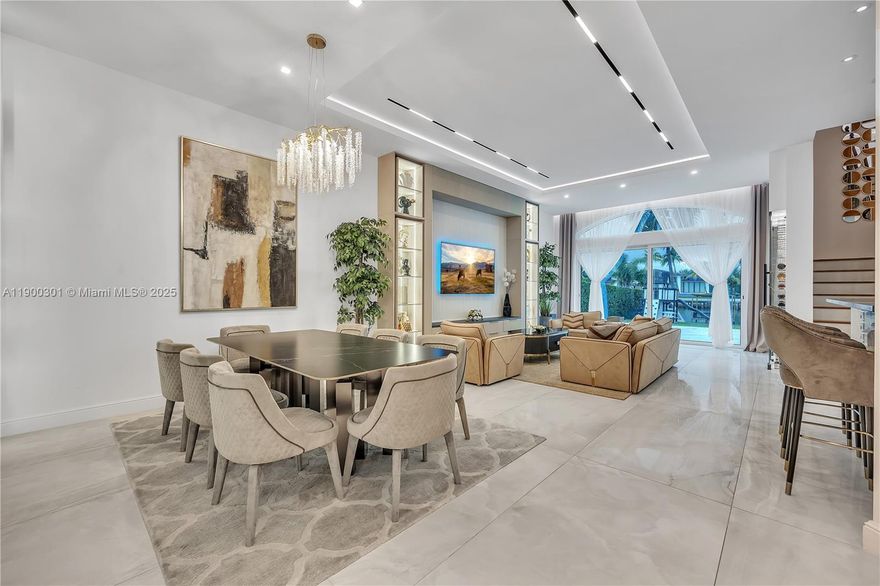 Experience the epitome of waterfront luxury living in this exquisitely furnished designer residence. Featuring 5 bedrooms and 4 bathrooms across more than 3,400 sq ft of refined interiors, this home showcases soaring ceilings and sophisticated finishes throughout. The detached guest house offers a private retreat. Enjoy serene water views from the oversized lot, complemented by a beautifully landscaped backyard and a heated pool—creating the perfect  resort-style comfort.