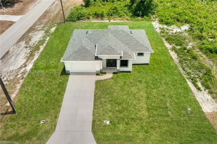 Don't miss this unique opportunity to own a spacious, brand-new 3-bedroom, 2.5-bathroom home with a den on a corner lot in Lehigh Acres. This beautifully designed home features an open floor plan that includes a large living area and kitchen island, perfect for entertaining! Home features quartz countertops, white soft-close shaker cabinets, stainless steel appliances, impact windows, sprinkler system, and a double car garage. The master suite is a true retreat, featuring two oversized walk-in closets and a bathroom with dual vanities and a walk-in shower.Additional highlights of this home include vinyl flooring, a 62-inch living room fan, kitchen pendant lights, and energy-efficient LED lighting throughout. Conveniently located near SWFL International Airport, FGCU, shopping centers.