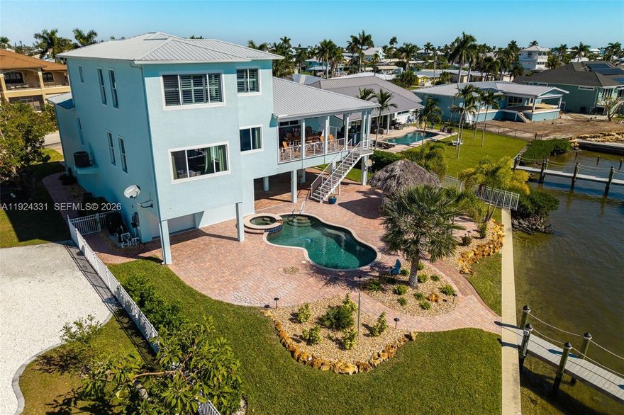 Experience luxury waterfront living in this fully renovated 3-bed, 3.5-bath San Carlos Bay estate with unobstructed deep-water Gulf-access views. Located on the southern tip of Pine Island in St. James City, it offers a peaceful Old Florida lifestyle minutes from Cape Coral and Fort Myers. Over $400K in upgrades include a new roof, spray-foam insulation, hurricane impact windows/doors, new HVAC systems, instant hot water, and a full-home generator. Boaters will love the premium dock with 6k and 15k lb lifts and no-bridge Gulf access. Outdoor amenities include a heated pool/spa, Tiki Hut, and full outdoor kitchen. Inside features high-end renovations, wide-plank tile, custom closets, and a chef’s kitchen with Jenn-Air appliances, exotic granite, and $250K in custom cabinetry. Offered tastefully furnished, plus an oversized 4-car epoxy-floor garage. A rare blend of security, luxury, and prime Pine Island waterfront living.