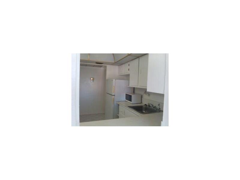 Rare find from this spacious 1/1.5 unit with ocean views. Plenty of closet space, including large walk in closet in master bedroom. Large den allows for additional living space or office. Partially tiled / carpeted. Very low maintenance. Walking distance to beach, shops, dining. Will not last!