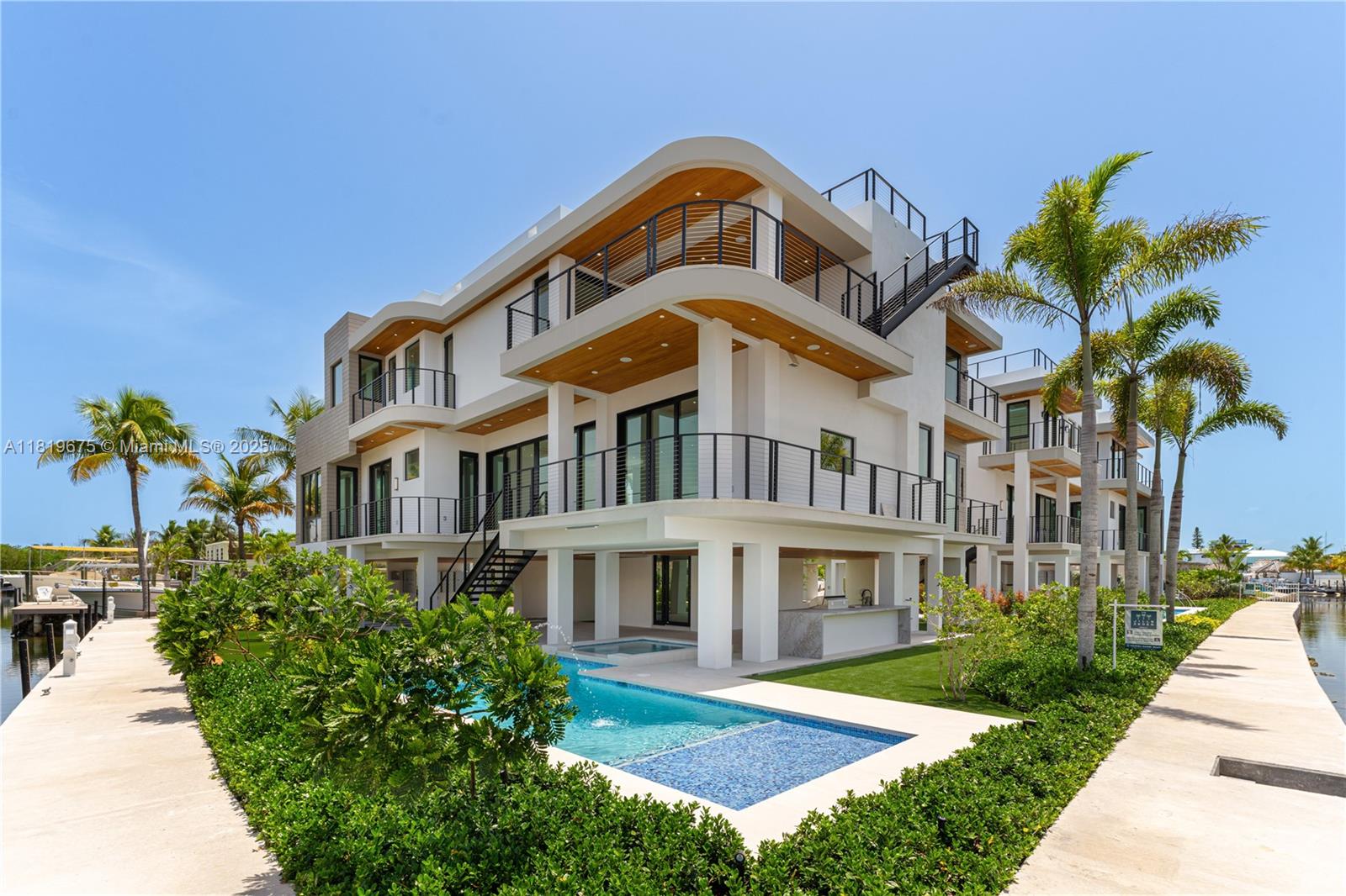 Extraordinary 6,043 Sq.Ft. waterfront home with the finest quality finishes, set in a private enclave at Buttonwood Circle. This entertainer's dream home offers spacious living and dining areas with a gourmet kitchen. Highlights include a gorgeous main suite with a spacious balcony and a luxurious bath equipped with a spa tub, separate shower, and large walk-in closet. Enjoy the desirable Florida Keys indoor-outdoor lifestyle with seamless access to landscaped grounds, which will include a sparkling pool, full summer kitchen, and private 45-foot dock. Featuring four additional bedrooms with ensuite bathrooms and a rooftop deck ideal for entertaining and enjoying spectacular views, this is a true retreat and a must-see!