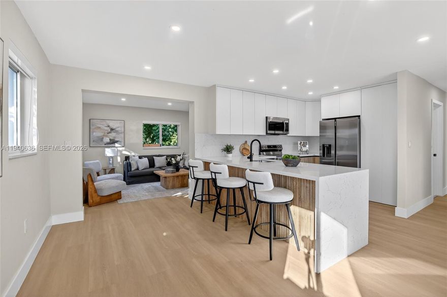 Imagine waking up in this stunning Miami Gardens home, just minutes from the iconic Hard Rock Stadium. Natural light pours through multiple windows, filling every corner with warmth and brilliance. With 3 bedrooms and 2 bathrooms, the home offers luminous, open spaces where daily life feels effortless and special.

The heart of the home is its open-concept kitchen—a true centerpiece—featuring sleek stainless steel appliances, white quartz countertops, and a spacious layout perfect for preparing meals, entertaining friends, or enjoying quiet moments together. It flows seamlessly into the living and dining areas, creating a bright, inviting environment where every gathering feels memorable.

The bathrooms are fully tiled, on both floors and walls, and showcase modern fixtures and recessed lighting, combining elegance and practicality. Throughout the rest of the home, durable, water-resistant vinyl flooring with a rich wood-look finish adds warmth and sophistication. Step outside to a generous backyard with trees and a convenient storage shed.

Located near major highways, shopping, and entertainment, this home offers easy access to everything Miami has to offer while remaining a private sanctuary. Every detail, from the abundant natural light to the stylish finishes, makes this home a rare find—a place where you can truly live your dream lifestyle and create memories that last a lifetime.