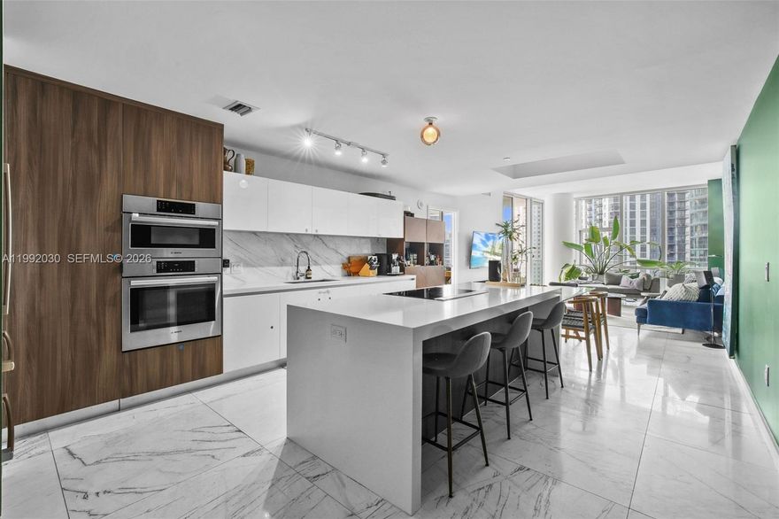 High floor corner unit in the more desired line in the building. 4 Bedrooms, 4 full bathrooms, (in the unit den, converted into a bedroom), with private foyer and elevator. Direct view of the Biscayne Bay. 10 ft high ceilings, upgraded marble floors, floor to ceiling impact windows, large terrace space, spa like master bath with dual vanities, separate shower, walking closet and much more to describe. Bosch appliances and sub-zero floor to ceiling fridge. Access to resort like amenities including two roof top pools, plus three resort style pools with towel service. Gym, tennis, racquetball, basketball, boxing, child play area, sauna/hot tub, clubhouse, yoga room, business center, party rooms, virtual golf, theatre room, 24/7 valet, security and front desk. World class restaurants and shopping in the new developed Miami World Center.