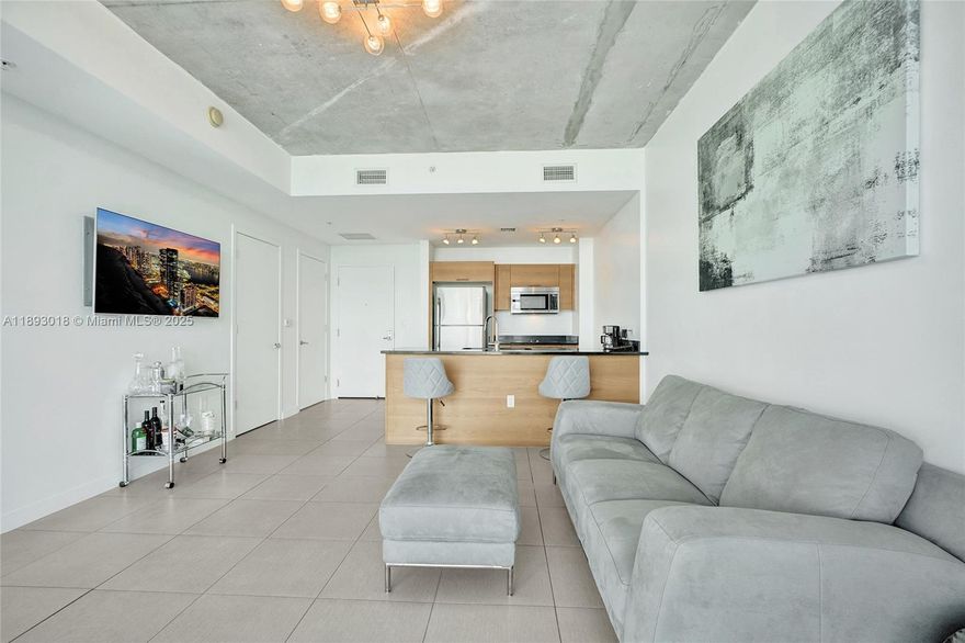 Experience modern urban living in the heart of Midtown Miami! This spacious 1-bedroom, 1.5-bath residence offers an open-concept layout with floor-to-ceiling windows that fill the space with natural light. The sleek kitchen features quartz countertops, premium stainless-steel appliances, and contemporary cabinetry — perfect for both cooking and entertaining. Enjoy a large primary suite with electric blinds and a walk-in closet. The private balcony offers stunning city views, ideal for morning coffee or evening relaxation. Resort-style amenities include a pool deck, sauna, steam room, gym, and 24-hour concierge. Just steps from the best shopping, dining, and nightlife that Midtown, Wynwood, and the Design District have to offer. 1 assigned parking included. Contact listing agent.