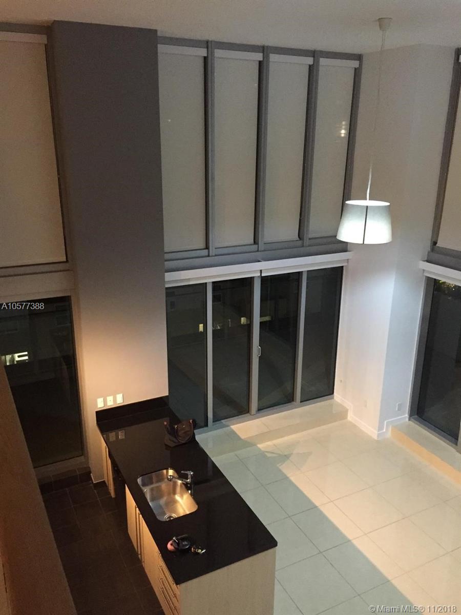 Truly one of the best 3-bedroom floorplans in Miami, two-story condo, great for families or roommates. 20-foot-high ceilings in the living area, full height glass walls of windows and a private 800+ square foot terrace overlooking the city. 3 bedrooms with 3 FULL bathrooms, an open kitchen with spacious living room, plus a second living room (den) or office upstairs overlooking the downstairs. Two bedrooms and two bathrooms on the first floor, with the Master bedroom and bathroom, plus the den on the second level. Master bath is very large with a stand-up shower, separate bathtub with custom tile work and double vanity.
