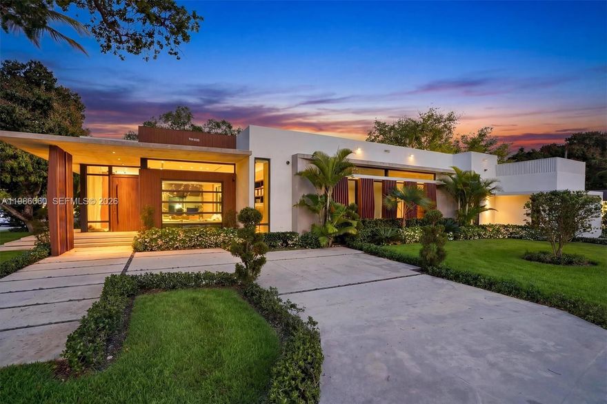 Villa Serene is a show-stopping corner lot estate where modern luxury meets coastal elegance, just steps from Biscayne Bay. Set on a 17,880 sq ft corner lot, this residence offers over 5,100 sq ft of refined living space with soaring 12-ft ceilings and imported Italian wood floors throughout. Designed for seamless indoor-outdoor living, every room opens to a resort-style saltwater pool, creating a private oasis ideal for both relaxation and entertaining. The chef’s kitchen features top-of-the-line Thermador appliances, a built-in hibachi grill, wine bar, and a pass-through to the outdoor kitchen. All bedrooms are en-suite, offering comfort and privacy. Smart home upgrades include Lutron lighting, whole-home water filtration, EV chargers, a 33kW generator, and advanced security. Additional highlights include double washers and dryers and expansive entertaining areas. Located in one of Miami Shores’ most desirable neighborhoods, Villa Serene is a rare turnkey opportunity and one of the area’s finest homes.   
 
*5th bedroom is a garage conversion