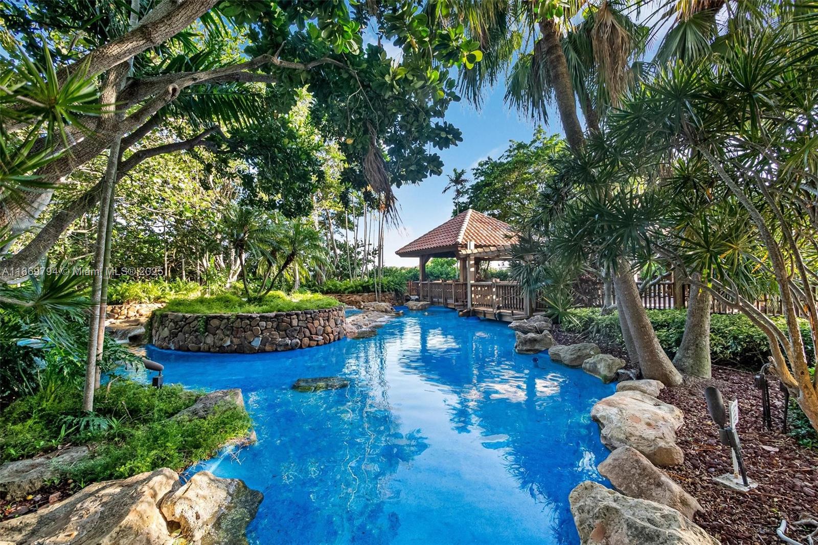 Rare corner unit on the 4th floor, thoughtfully converted into 3 bedrooms and 2 bathrooms, offering serene garden views with lush greenery, ponds, and soothing fountains. Located in a private 34-acre gated waterfront community featuring a marina, 24/7 security, resort-style spa, pools, jacuzzi, steam and sauna. Monthly maintenance includes water, hot water, high-speed internet, cable, and daily classes such as yoga, spinning, and aqua aerobics. Enjoy on-site dining at the marina restaurant or spa café. Beautifully maintained community with no assessments and completed 40-year certification. A true lifestyle of comfort and relaxation!