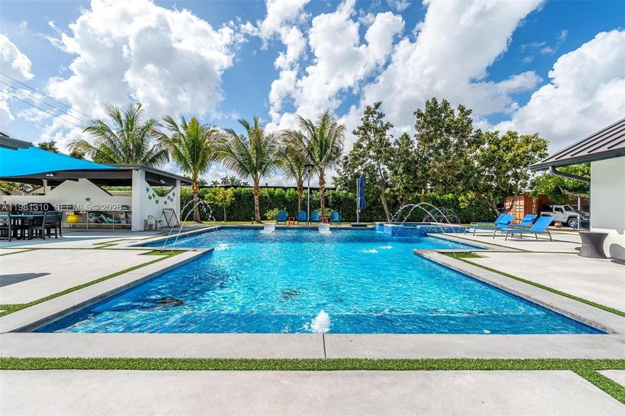 Tucked in Miami-Dade’s beloved Redland agricultural area, this estate offers the rare combination of space, privacy, and convenience! Set on nearly a full acre, the property creates a private tropical setting surrounded by 40 fruit trees and outdoor space designed for relaxation and entertaining.

Inside, the home offers over 4,000 sq ft of actual area with 6 bedrooms and 5.5 bathrooms, including 3 en-suite bedrooms, making the layout ideal for larger households, guests, or multi-generational living. The home features a main kitchen plus a separate butler’s kitchen, perfect for hosting gatherings or catering events, along with two laundry areas.

The backyard is the centerpiece, featuring an oversized approximately 1,500 sq ft heated saltwater pool & spa, creating a resort-style outdoor experience. A cabana bathroom, entertaining areas, and yard space make it ideal for gatherings or quiet evenings at home.

The fully fenced property provides space for boats, RVs, multiple vehicles, and recreational equipment, along with a 3-car carport with electrical.

Additional highlights include metal roof, impact windows & doors, quartz countertops, LED lighting throughout, working wood-burning fireplace, whole-house water softener, and irrigation system on well water.

Located in the Redlands without being too deep into the agricultural area, this property offers space, flexibility, and the lifestyle that makes this area sought after.
