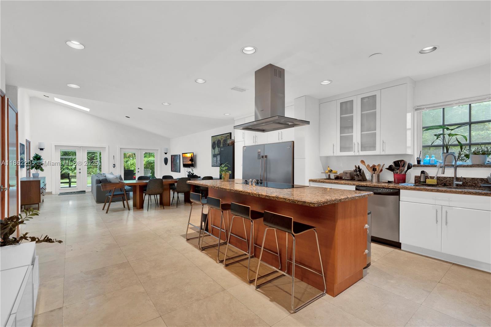 Discover this classic Coconut Grove residence, situated in the sought-after Southern Grove neighborhood. Featuring soaring 14-foot vaulted ceilings, abundant natural light from 5 new skylights, and an updated custom open kitchen this home blends timeless charm with modern comfort. Main residence offers 3 bedrooms and 2.5
bathrooms, highlighted by a stunning primary suite with 14-foot ceilings & a 250 sq. ft. walk-in closet. Separate 1-bedroom, 1-bath cottage is the ideal space for guests, in-laws, or a private office. Enjoy seamless
indoor-outdoor living with four sets of impact doors opening to a spacious 650 sq. ft. covered terrace and BBQ area perfect for entertaining family and friends. Additional brand-new A/C & updated roof (2021/2022).