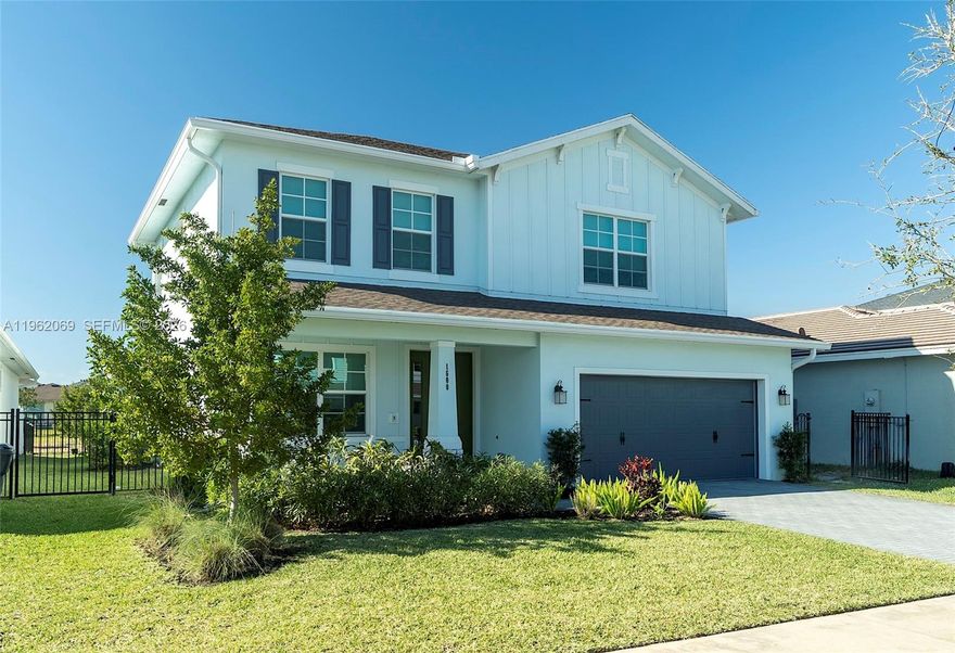 Recently built, handsomely appointed 2-story home available in Arden for sale. If you enjoy a relaxed, but sophisticated vibe, this house is for you!  Come see for yourself the Shiplap Walls, upgraded countertops with waterfall island, upgraded closets, crown-moldings throughout, Ox-Floor garage with transferable warranty (for 10 years from original purchase), hardwood floors on stairs and throughout second floor and water treatment system...and don't forget the backyard- enjoy your patio and backyard designed for entertaining with family and friends. Your oasis is complete with fruit trees for healthy snacking and shade. With Arden's unparallelled community amenities, close proximity to Palms West hospital, Aldi's, Publix and other conveniences as well-regarded middle school and high schools, this total package will not last!