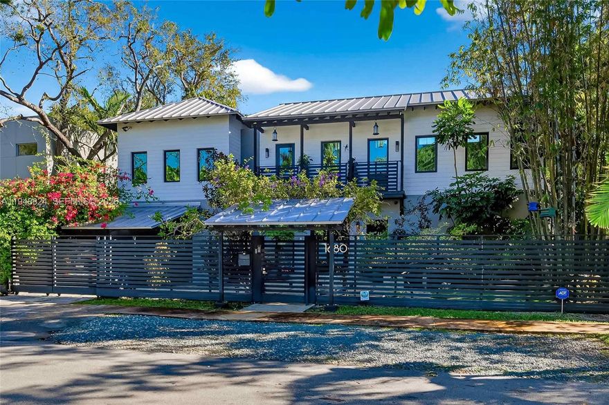 Exquisite North Grove sanctuary, exceptionally well located on a prestigious, quiet, tree-lined street.This immaculate residence blends timeless elegance with modern comfort. Sun-filled interiors flow from a stunning chef’s kitchen with gas range into expansive living and dining areas with serene garden views. Custom woodwork and built-ins enhance the home’s refined character, complemented by two eco fireplaces. The spacious primary suite is filled with natural light and overlooks lush greenery, featuring a beautifully appointed spa-style bath with refined finishes and steam shower. Outdoor living is highlighted by a spectacular heated lap pool and a summer kitchen with pizza oven, all surrounded by mature trees for exceptional privacy. Move-in ready with an updated interior totaling approximately 3,200 square feet, and ideally located near CocoWalk, Brickell, and Downtown Miami—an exceptional opportunity in one of Miami’s most sought-after neighborhoods.