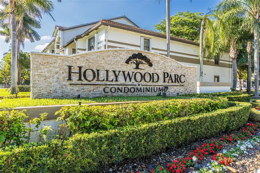 Ground floor 2-bedroom, 2-bathroom unit in Hollywood Parc with updated bathrooms, a breakfast bar kitchen, a newer AC unit, ceiling fans in bedrooms, and in-unit washer/dryer. The community features a pool and tennis court and is conveniently located.
