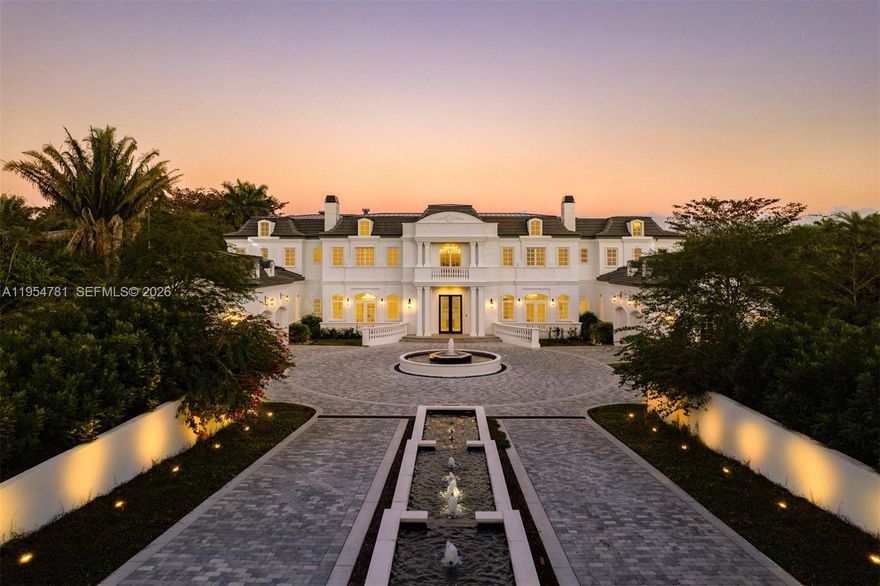 Set on nearly 2 acres and approached by a grand circular driveway with a dramatic 90+ ft cascading fountain, Château du Soleil showcases award-winning architecture by Ramon Pacheco. Inspired by classic French château design, the estate blends timeless elegance with modern luxury, featuring soaring ceilings, fireplaces, dormer windows, and exquisite wall detailing. A striking two-story library anchors the home, complemented by a private theater, gym, elevator, staff quarters, and three staircases. The primary suite offers expansive walk-in closets and a private terrace, while additional suites enjoy balcony views. Resort-style grounds feature lush lawns, koi pond, covered terraces, summer kitchen, gazebo with fire pit, cabana bath, and room for a future sports court near elite Pinecrest schools.