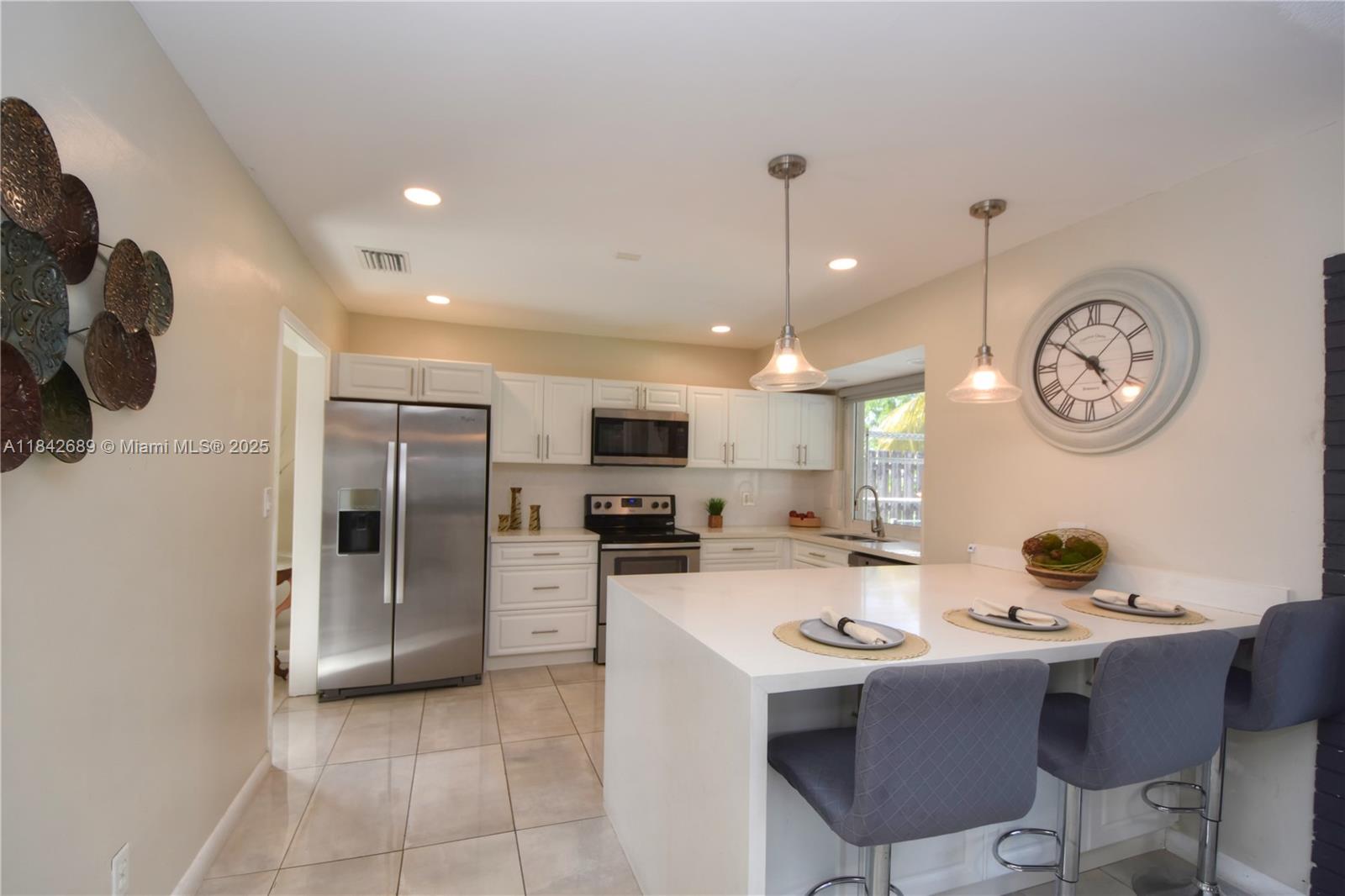 Beautiful updated pool home in the heart of Hollywood Hills! 3 Bed 2 bath home. Spacious, light and bright! Home features a spacious living room with bay windows, open dining room, updated kitchen with quartz waterfall countertop with breakfast bar, stainless steel appliances, fridge, microwave, oven, dishwasher and sink. Brand new washer and dryer. Gorgeous new floors through out living areas. Has an open floor plan and is perfect for a family and entertaining. Don't miss out on this property as it wont last long! NO HOA easy approval and easy to show. Please provide RENT SPREE. New Roof and all windows are impact! Can be semi furnished but doesn't have to be!