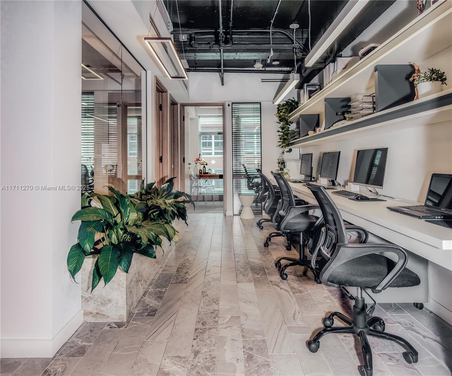 PRIVATE OFFICE FOR RENT at the iconic One Flagler Building, designed by renowned architect Morris Lapidus – a modern renovated boutique building at the heart of downtown Miami. 725 SqFt office completely renovated & furnished by professional Interior Designer – beautiful, modern & efficient designed to inspire productivity and creativity. Features floor-to-ceiling windows, marble-style flooring, high-end custom-made cabinetry throughout & and lots natural light, on the 9th Floor. 2 private offices, 4 work stations, meeting room & kitchen.
One Flagler's sleek lobby has 24/7 security and front desk attendant. walking distance to Biscayne Blvd, Restaurants, Whole Foods, and Metro Mover stations. FLEXIABLE TERMS – Possibility to rent fully or partially as well