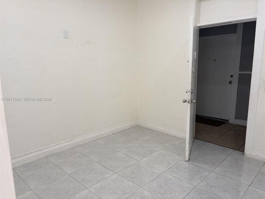 This spacious 1 bedroom one bathroom apartment is located across the street from the highly coveted coral gables neighborhood. This unit is in a historic building located in the City of Miami on the second floor of a garden walk up with five retail spaces on the ground floor. There are only eight apartments in the building, and every tenant is quiet and cordial with the patrons and other tenants. 
The building is familiarly recognized as the building adorned with a Miami Marlins mural painting painted by the artist a few years back. The apartment offers plenty of natural light and views of Calle Ocho streets. Unit has a large refrigerator with plenty of freezer space. No central air conditioning instead there is a mini split air conditioning unit located in the master bedroom. Rest assured as there are no gas lines running into the building as all the wiring and appliances have been updated to electrical. From the hallway enter into the living area, the kitchen is located to the left with enough room for a small dine-in table. Continue through the living area door into the spacious bedroom with window lighting. To the left of the room is a foyer with a closet adjacent to the bathroom with granite like tiling and a walk in shower. This is not a small one bedroom, if you have existing furniture it should showcase nicely within this unit. Parking is available for at least one car. Two cars may be available upon request. Contact the agent a few hours prior to showing. Not on LB.