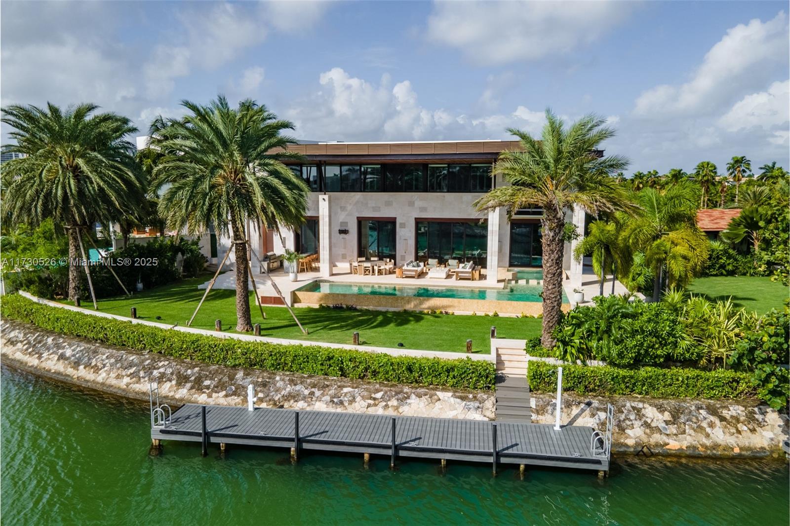 Located in one of the most exclusive areas of Cancun is this impressive residence that redefines luxury & comfort. Every detail has been carefully selected to offer an unparalleled living experience. Main house is 1502m2. Main level is perfect for entertaining, with great room, bar, dining, kitchen, breakfast nook & media room. There is also a large office. Step outside to the lanai, pool & outdoor kitchen. Access to 2 full ext baths. Upstairs are 5 Bdrms, 3 are en suite. Basement level is for the car enthusiast with room for 6 cars, an area for all your auto tools, as well as a bunk room & 3 full baths. Guest house has 1 bed, 1.5 baths, pool, garage for 3 cars.Games room has mens & womens bathrooms. All this sits on over ½ acre of land. Boat docks, room for up to a 60’ boat. MLW of 3’.