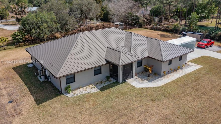 STUNNING 2022-built 5 BEDROOM, 3 BATH home on 1.15 fully fenced acres with remote gate in a TOP RATED SCHOOL SYSTEM in JUPITER FARMS!. Enjoy an open-concept layout where luxury abounds with sleek porcelain floors, soaring ceilings and a chef’s kitchen featuring granite counters, built in oven with warming tray, induction cooktop, tons of cabinetry and a large island. The triple-split bedroom plan includes a spacious master suite with dual closets and a spa-like bath with walk-in shower, soaking tub, and double vanity. Custom California closets in all rooms. Relax on the 56x10 screened patio with friend and guests. Extras: Metal seamless roof,  plantation shutters, tankless water heater, epoxy garage floor, tons of built in storage, HUGE laundry room and SO much more. Room for a pool, or stalls so bring your horses!  Experience peaceful country living WITH ROOM TO GROW—welcome to the Farms!