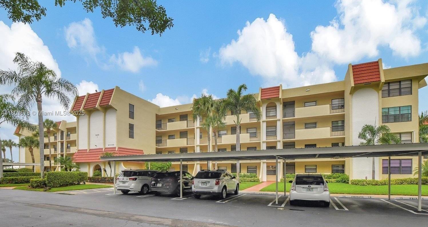 Priced to Sell! Beautifuly maintained clean and neat 2-bedroom, 2-bath condo Pines at Boca Barwood (55+community). Features include: lovely kitchen with updated white cabinets, Cozy breakfast nook, Neutral wood porcelein-tile in entry way and kitchen, impeccably maintained neutral baths and spacious primary suite with a walk-in closet. In-unit laundry appliances and assigned carport parking add everyday convenience , plus storage on the patio. Roll-down hurricane shutters in patio. The community offers clubhouse, Tennis, gym, and well-manicured grounds. Great Location, walking distance to supermarkets, restaurants, banks and public transportation.