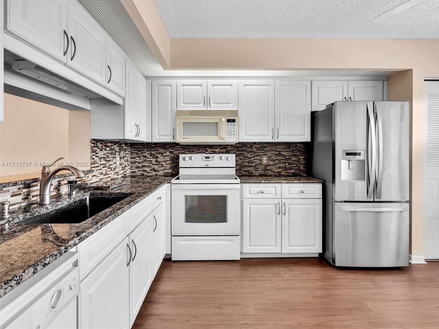 Welcome home to this stunning 2-bedroom, 2-bathroom condo that offers the perfect blend of comfort and convenience. Relax on your private patio and enjoy the breathtaking golf course and serene lake views. The spacious kitchen boasts granite countertops and new cabinetry with ample storage. A tankless water heater and in-unit washer and dryer add an extra layer of convenience to your daily living. This vibrant community offers an array of amenities, such as a clubhouse, pickleball courts, fitness center, pools, and a dynamic social calendar designed to foster connections and camaraderie. With HOA fees covering water, cable, roof maintenance, and more, you can enjoy peace of mind and a worry-free lifestyle. (SELLER WILL PAY $5,000.00 TOWARDS CLOSING COST)!