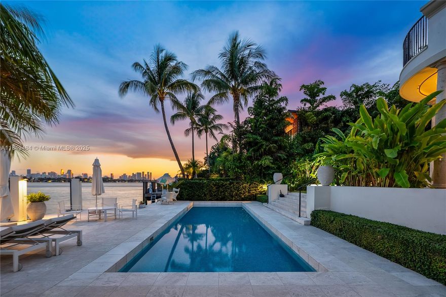 Located on the prestigious Sunset Island III, this exquisite 6-bed, 5.5-bath Spanish-style home blends timeless elegance with modern comfort. Soaring 12’ ceilings, French limestone floors, and a coral stone courtyard set the tone for refined indoor-outdoor living. The kitchen features a Calacatta marble island, Wolf appliances, gas stove, and dining area—seamlessly flowing into the family room with captivating water views. Upstairs, enjoy 10’ ceilings, Brazilian cherry wood floors, & a primary suite with dual walk-in closets & a private terrace overlooking Biscayne Bay and the Miami skyline. A detached guest house offers privacy and flexibility. Your backyard escape awaits with a heated saltwater pool, outdoor shower, and private dock offering direct access to the bay.