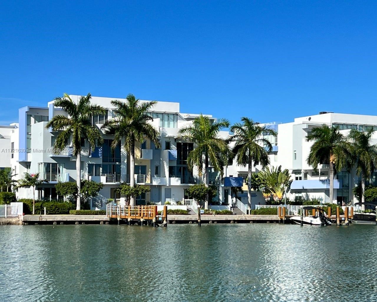 Stunning, contemporary 4-story corner townhome, directly on the water. Abundance of light, direct water view balconies on each floor. Amazing private roof top terrace. Open concept kitchen. This home was never rented and only used as a second home. 2 car garage with an additional parking spot. Serene waterfront community pool and very low HOA fees. Gated complex with 24 hours surveillance. All impact windows. Across the street from park, tennis, soccer, basket ball and playground. 5 minutes from the beach (gorgeous North Beach Oceanside Park), shops and restaurants. Many new high end developments are making this area the new place to be. Dont miss out on this opportunity to own a waterfront property in this highly sought after area.