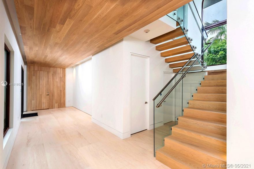 Stunning new waterfront home offers idyllic island living on guard-gated Sunset Island 4. Transitional street appeal with modern interiors offering comfortable ambiance. Foyer entry, large spacious living room with bar and glass wine cellar with stone floors. Large master suite w/sitting area with wood floors. Modern kitchen with adjacent breakfast area. Rear patio area with summer kitchen provides indoor and outdoor living. Detached guest house.