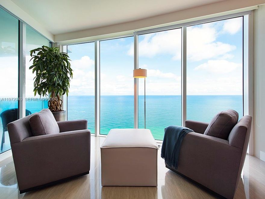 Experience true direct oceanfront living in this exceptional flow-through residence in the heart of Hollywood Beach. With coveted East-West exposure, this 3-bedroom, 3.5-bath luxury condominium captures breathtaking, unobstructed views of the Atlantic Ocean and stunning sunset vistas over the Intracoastal. Designed for both elegant entertaining and effortless coastal living, the open-concept layout seamlessly connects the living, dining, and chef’s kitchen areas — all framed by floor-to-ceiling glass and expansive terraces. A versatile bunk room provides ideal overflow space for guests, making this residence equally attractive for end users and investors seeking strong rental appeal. Finished in immaculate condition with white porcelain floors throughout, the unit exudes a clean, modern sophistication. Furniture is available for a turnkey opportunity. Residents enjoy over 240 feet of pristine Atlantic beachfront and access to resort-style amenities including: • State-of-the-art fitness center & spa • Social room, wine & cigar lounges • Poolside café with beach service • 24-hour security & concierge • Pickleball, tennis & basketball courts Pet-friendly (with weight restrictions), and ideally located just moments from vibrant shops, dining, and entertainment. This is coastal luxury at its finest — refined, private, and effortlessly connected to the best of South Florida living.